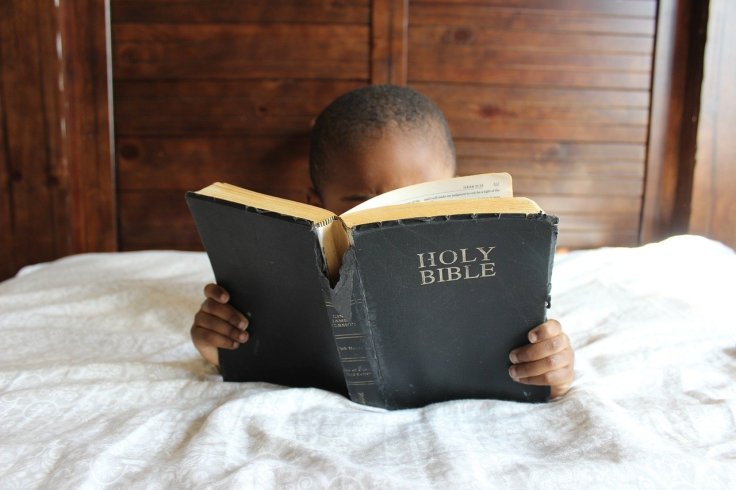 Boy Bible Reading in Bed